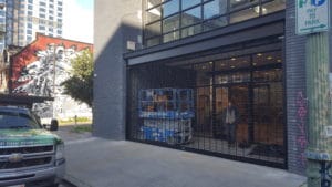 Dark bronze security gate in storefront